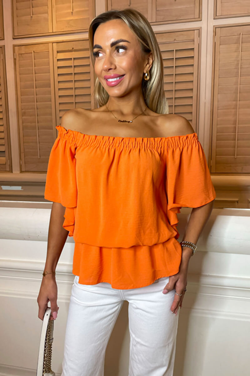 Orange ruffle top deals